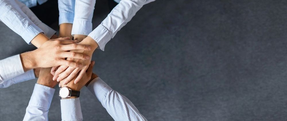 Team stacking hands together