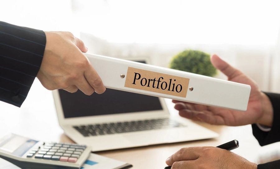 A portfolio being handed across a desk